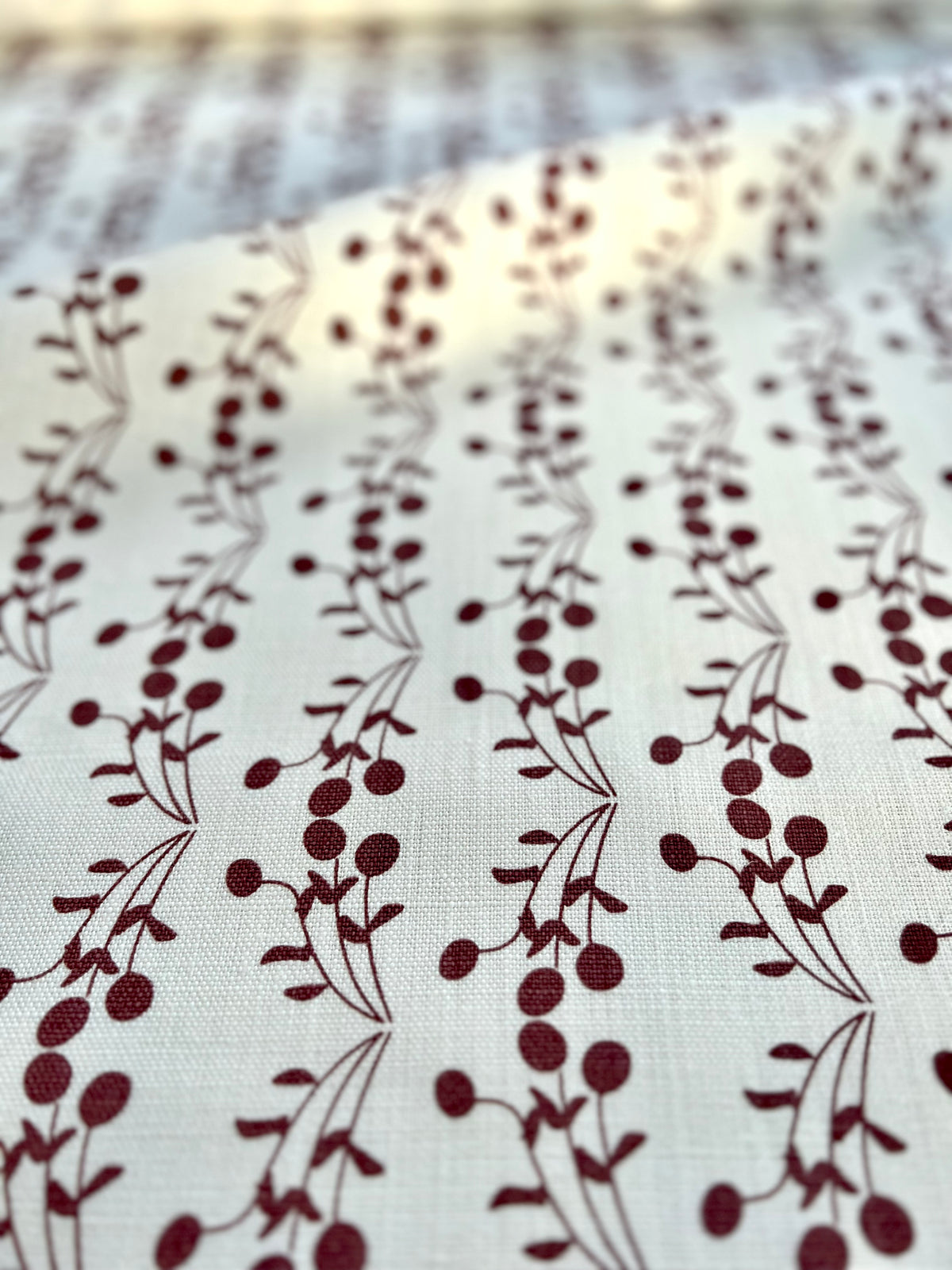 Bernadette fabric — a whimsical botanical print on Belgian linen, ideal for layering into interior spaces as curtains, accent cushions, or decorative upholstery.