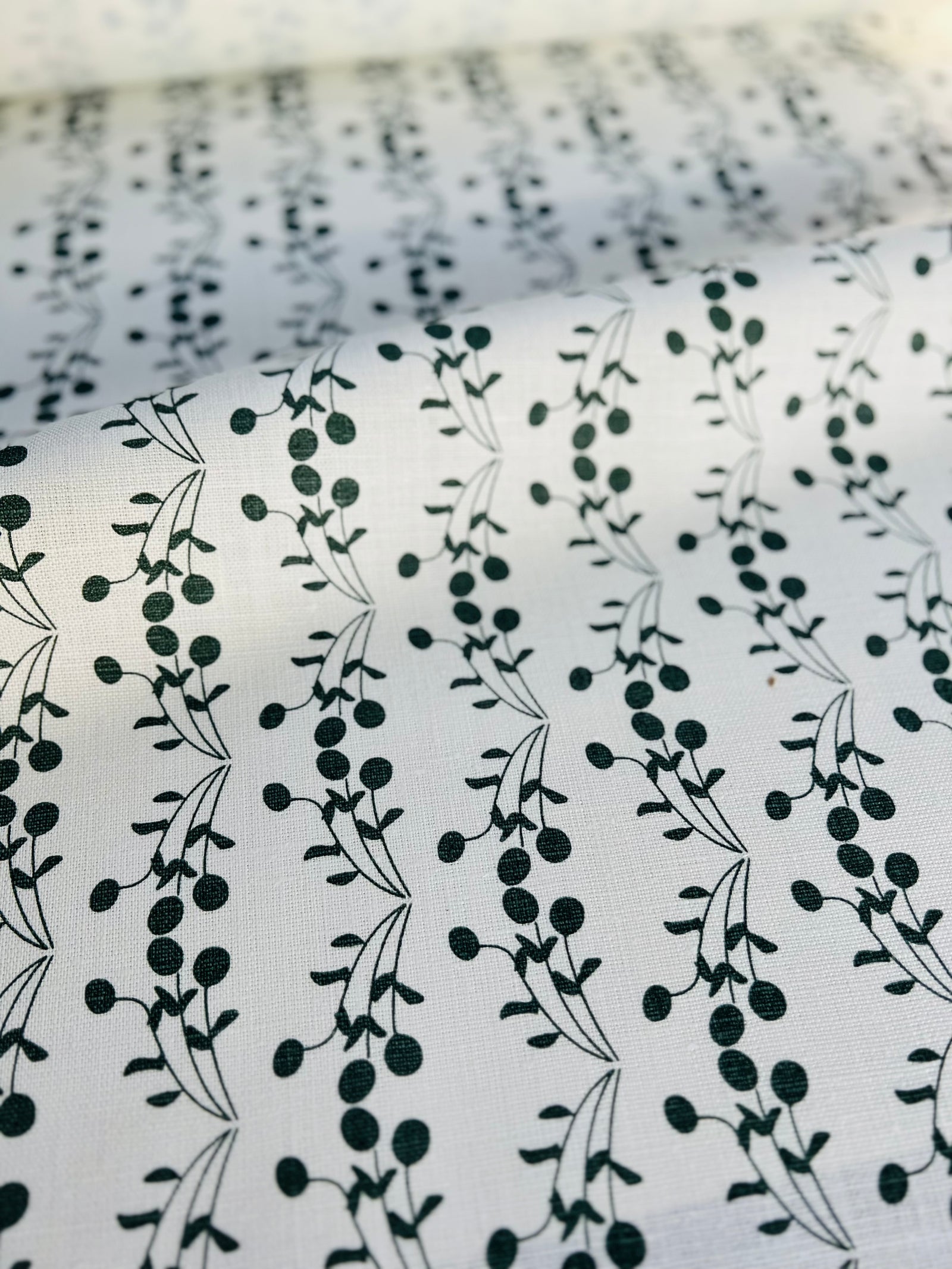 Bernadette pattern — featuring fruit tree motifs hand-printed on Belgian linen, this fabric is designed for timeless interiors and can be used across drapery, soft furnishings, and upholstery.