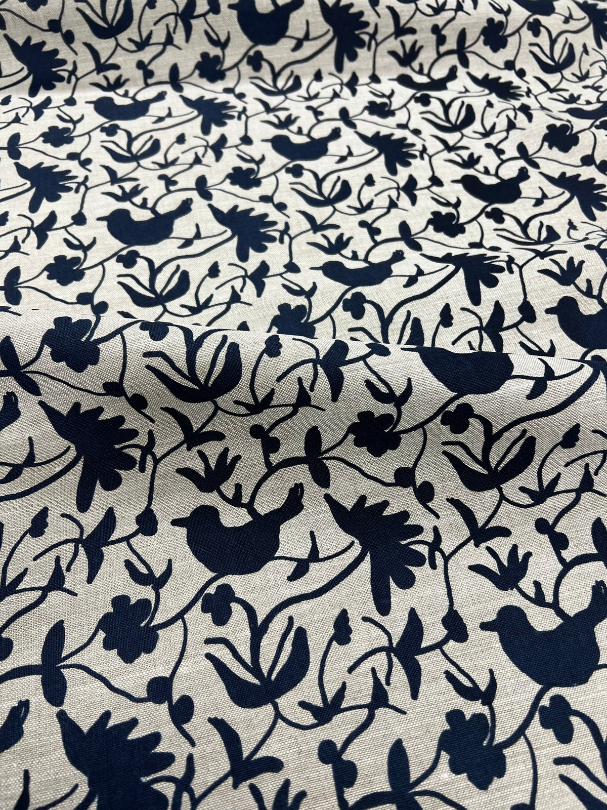 Greige Textiles’ Eliza pattern — an expressive floral and bird motif, screen printed on natural Belgian linen for timeless appeal.