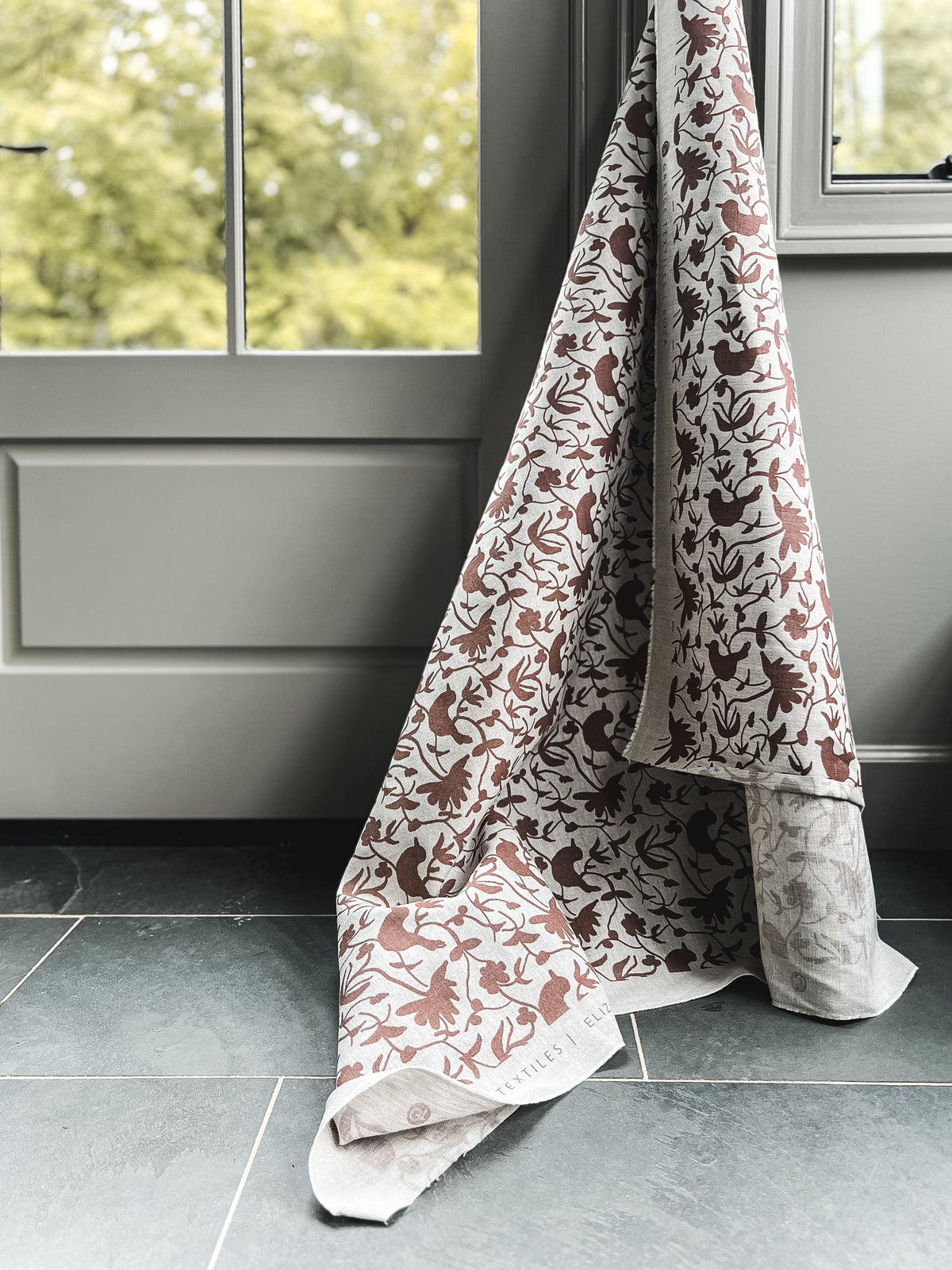 Hand-printed Eliza design — featuring a whimsical mix of birds and botanical forms, created for refined, nature-rich interiors.