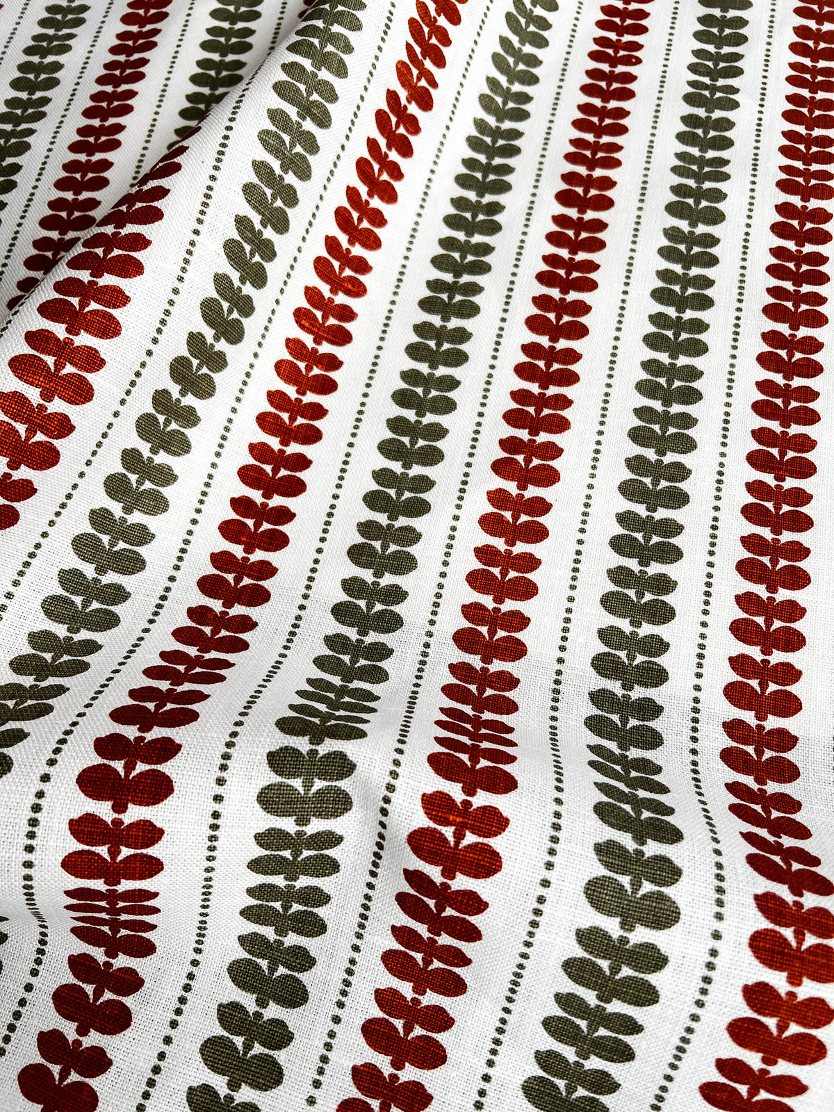 Greige Textiles’ Elodie design — a refined floral stripe that brings movement and softness to drapery, upholstery, and custom accents. Orange and green