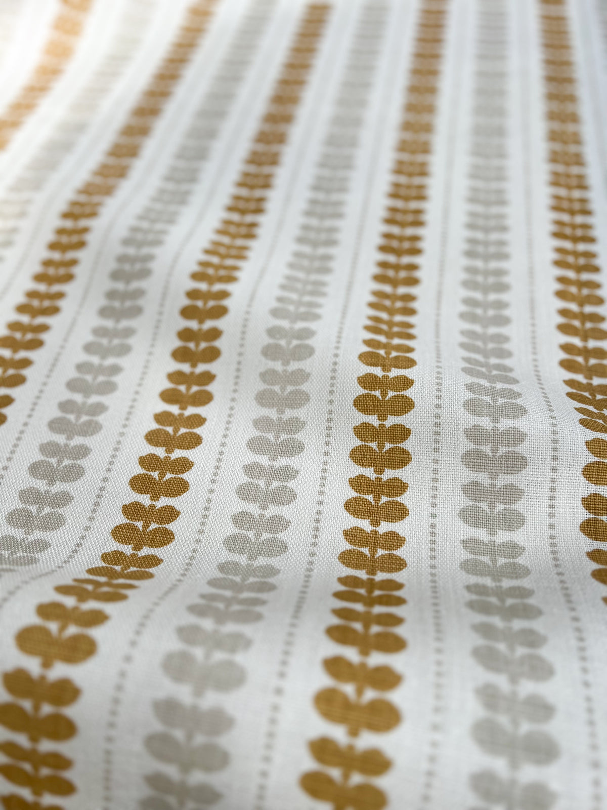 Artisan screen-printed linen with Elodie’s floral stripe design — delicate botanical elements arranged in a subtle, repeating rhythm. Wheat and Heron on Oyster