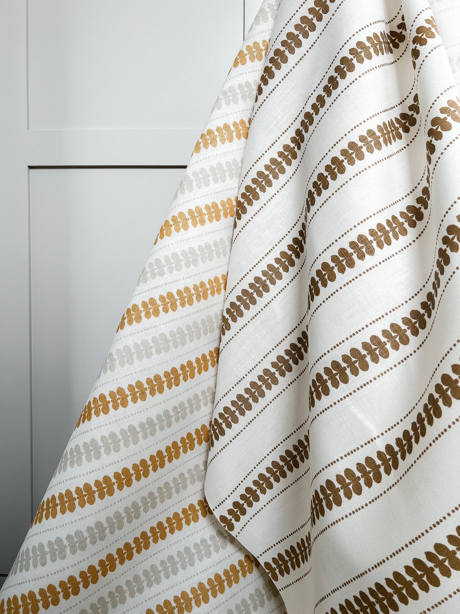 Greige Textiles’ Elodie design — a refined floral stripe that brings movement and softness to drapery, upholstery, and custom accents. Gold and oyster