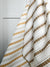 Greige Textiles’ Elodie design — a refined floral stripe that brings movement and softness to drapery, upholstery, and custom accents. Gold and oyster