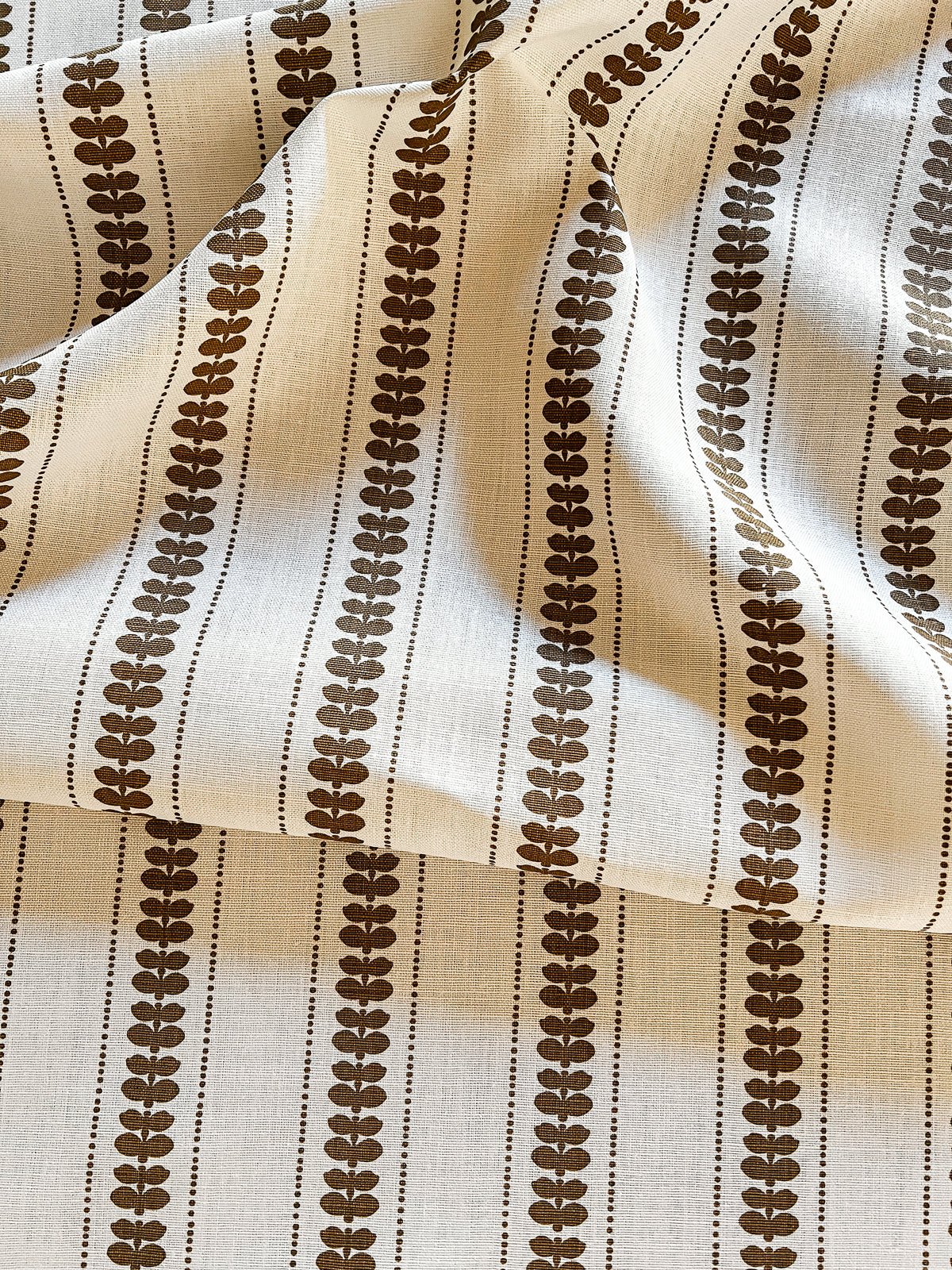 Greige Textiles’ Elodie design — a refined floral stripe that brings movement and softness to drapery, upholstery, and custom accents. Gold and oyster