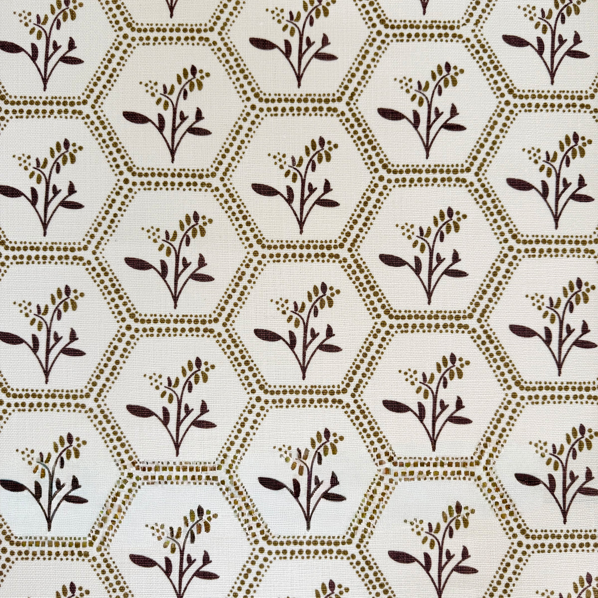 Greige Textiles Enid from Collection 12, a graceful decorative fabric pairing geometric honeycomb structure with delicate Astrantia blooms