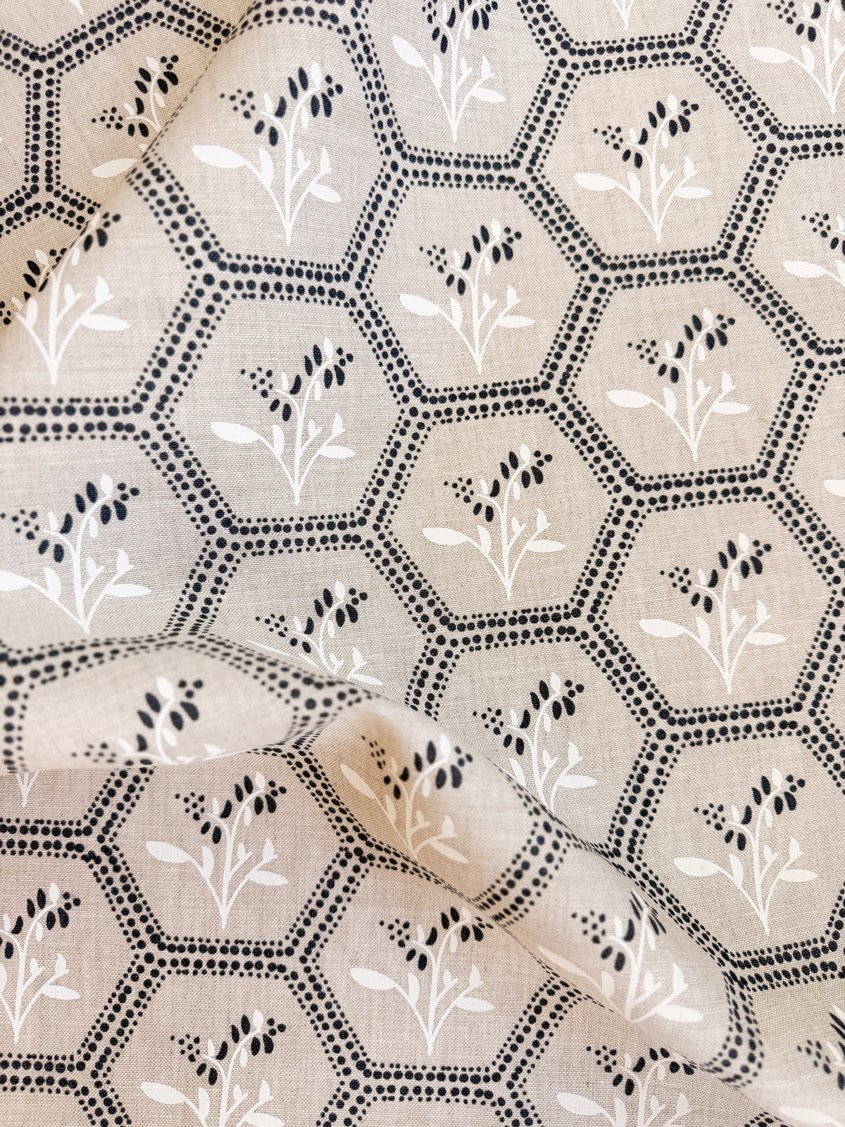 Enid by Greige Textiles, a timeless textile design blending geometric honeycomb structure with delicate botanical blooms