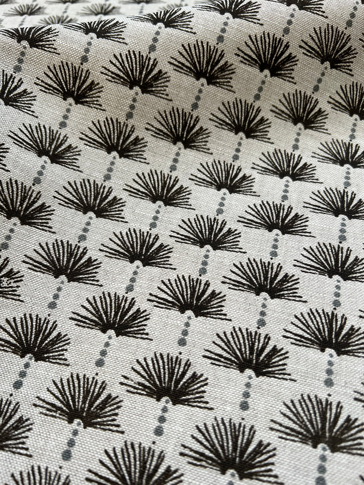 Nathalie Fabric Pepper and Azure on Oatmeal greige textiles  Inspired by the delicate detailing of Parisian doors and archways, Nathalie brings a sense of quiet refinement. Its subtle patterning evokes timeless charm, offering warmth and texture to sophisticated interiors