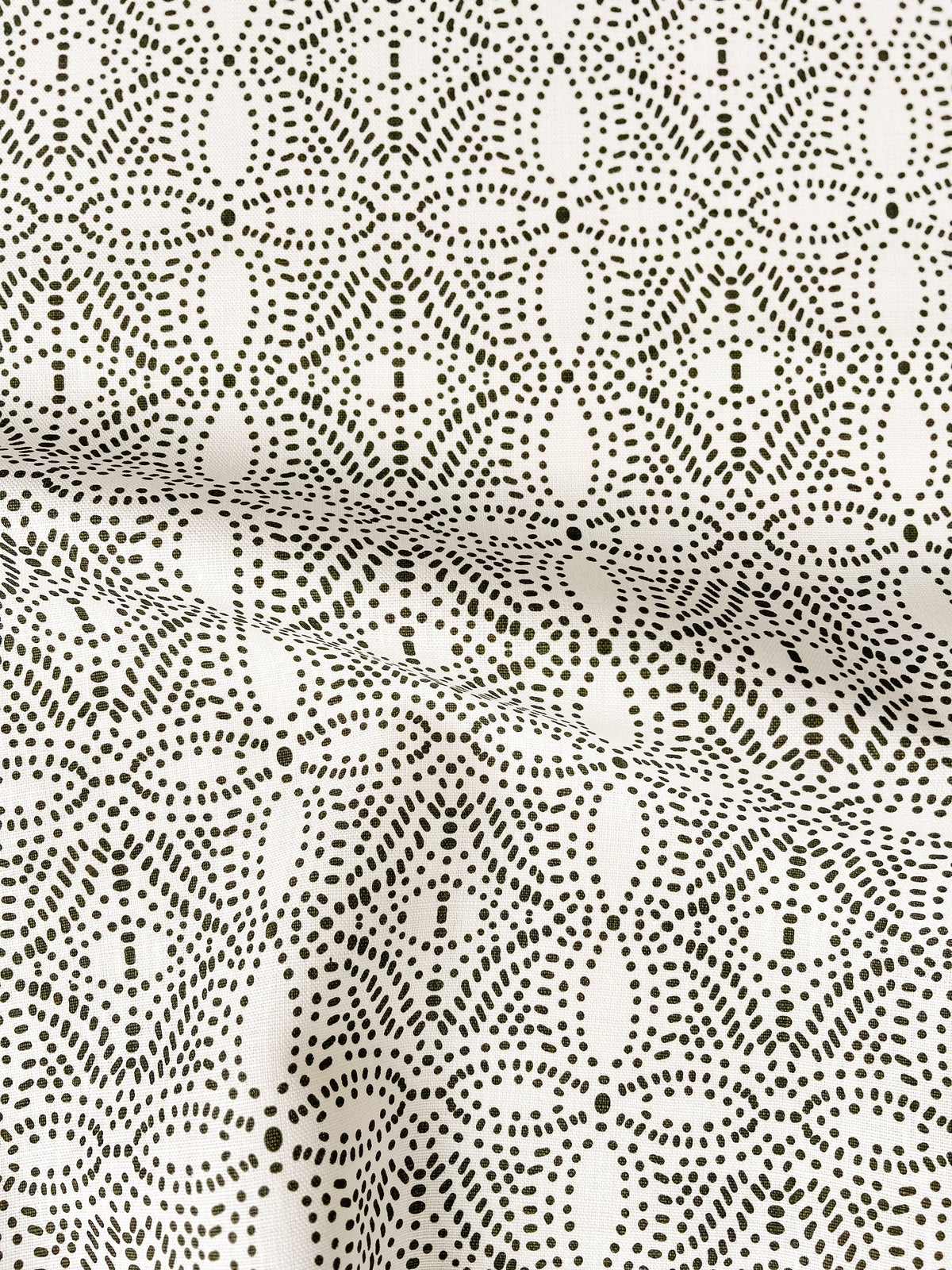 Greige Textiles’ Nell fabric brings a botanical, light-inspired design to accent chairs—perfect for fresh, airy interiors with an artisan touch