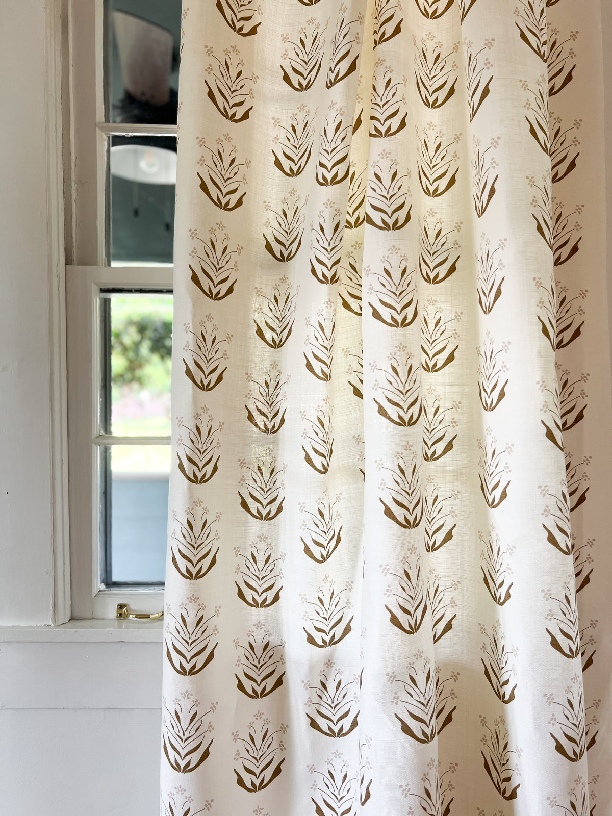 Greige Textiles’ Paige fabric—an artisanal print echoing early Zinnia blooms, ideal for custom headboards or bedding accents and drapery.