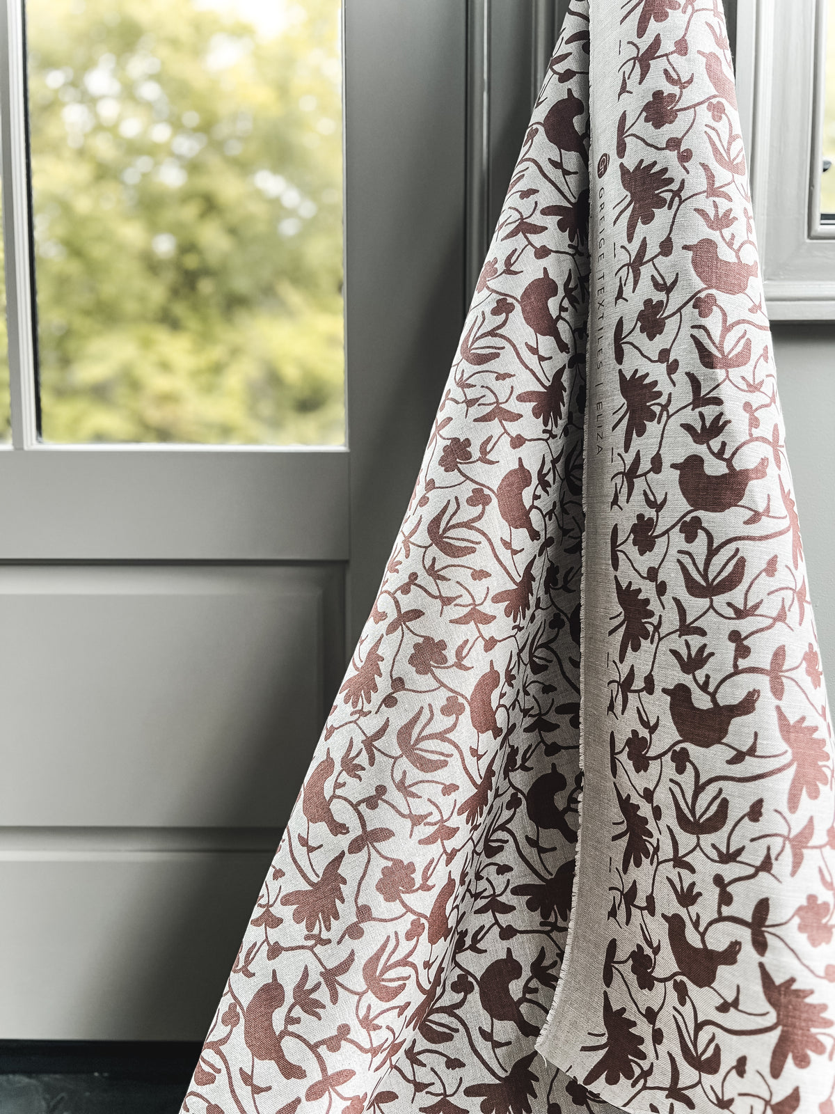 Hand-printed Eliza design — featuring a whimsical mix of birds and botanical forms, created for refined, nature-rich interiors.