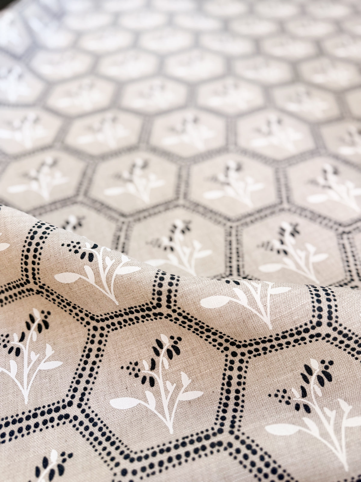 Enid by Greige Textiles, a timeless textile design blending geometric honeycomb structure with delicate botanical blooms
