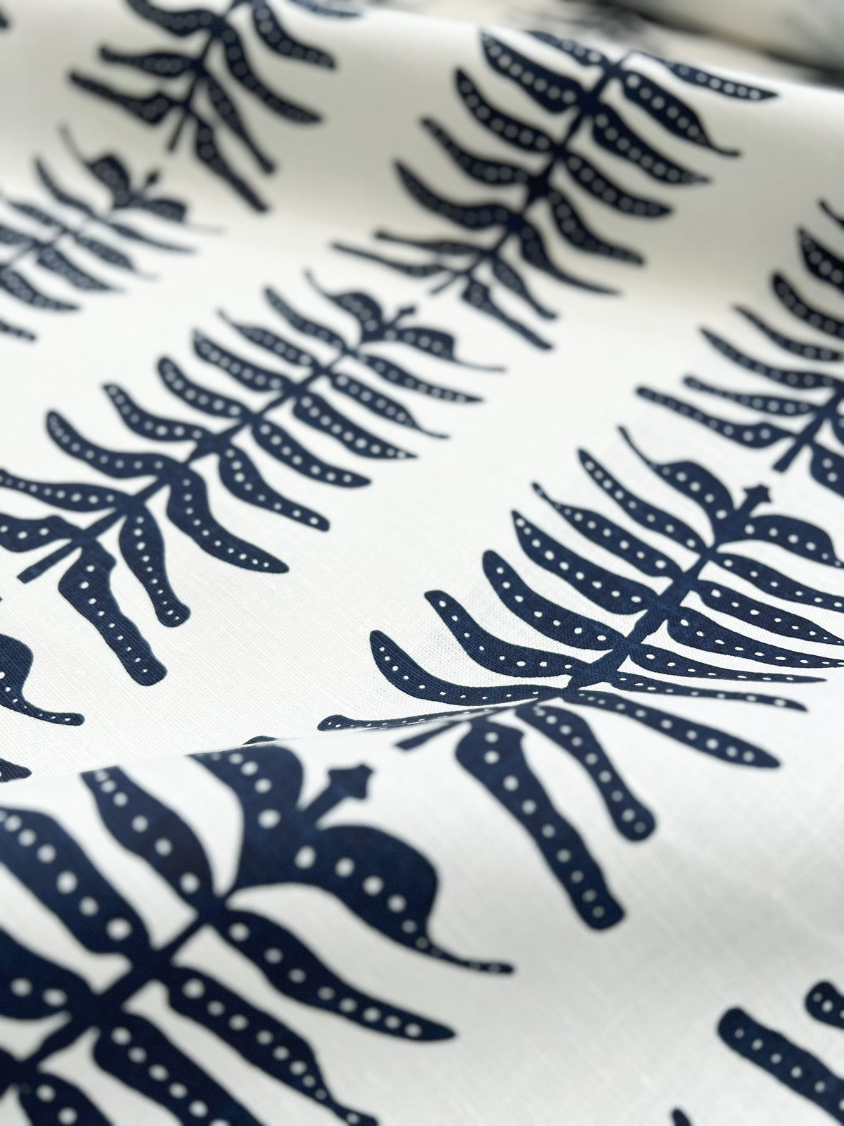 greige textiles Odette Fabric Indigo on Oyster. Greige Textiles blends bold color and heritage design in hand-printed linen fabrics and wallpapers—crafted for thoughtful interiors.