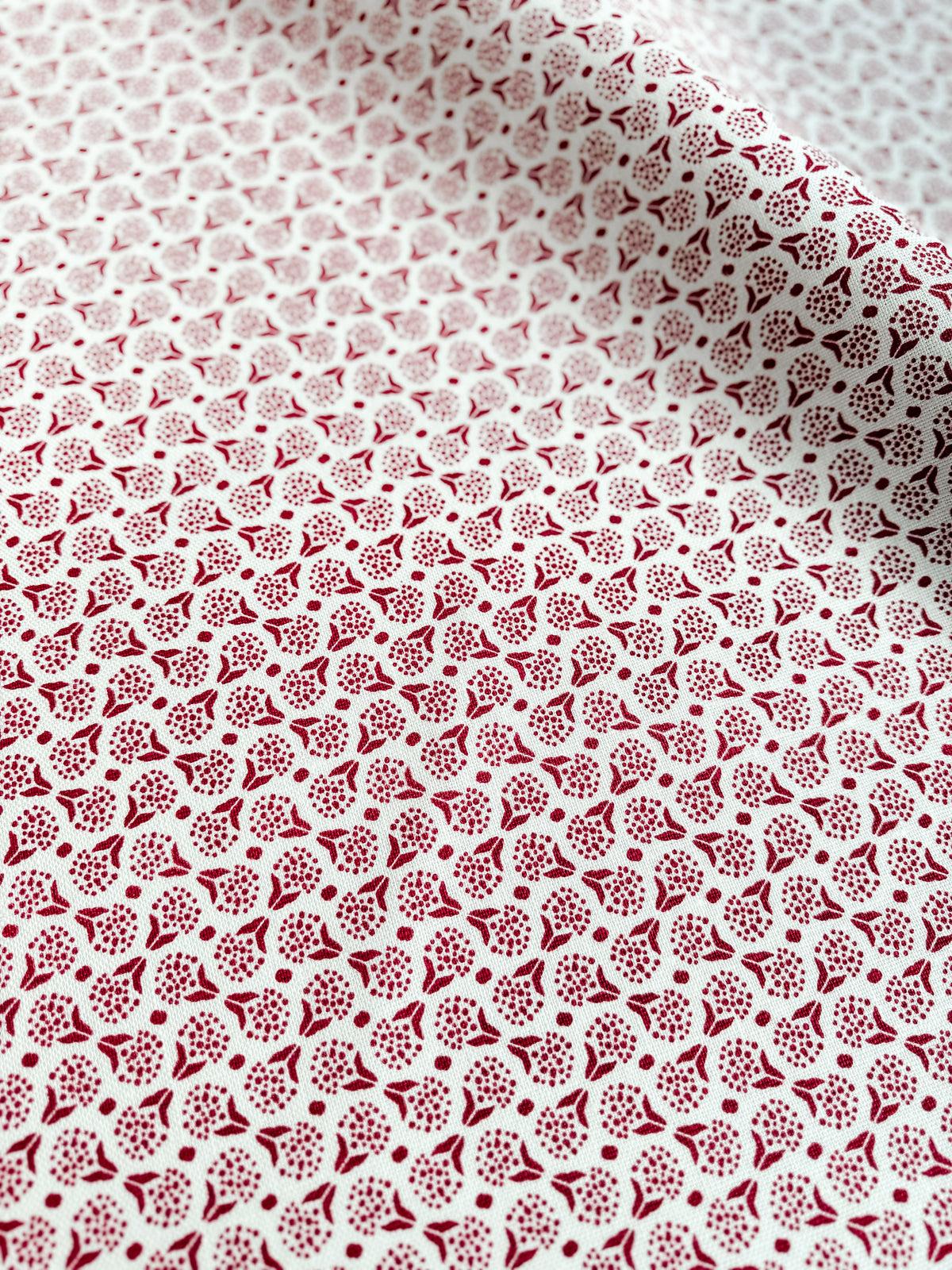 Explore a collection of colorful, artisan-crafted fabrics, wallpapers, and home accents featuring new heritage patterns hand printed on 100% linen at greige textiles. greige textiles izzy red on oyster fabric.