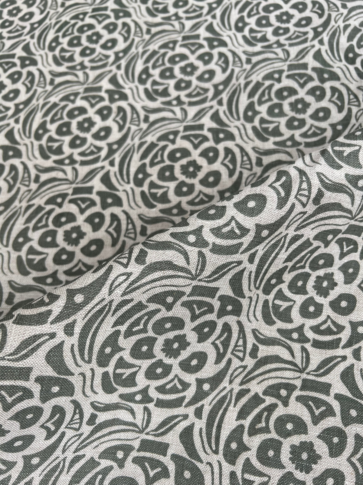 Greige Textiles’ Ida pattern — a hand-drawn botanical motif screen printed on 100% Belgian linen, designed for interior design professionals green on natural linen 