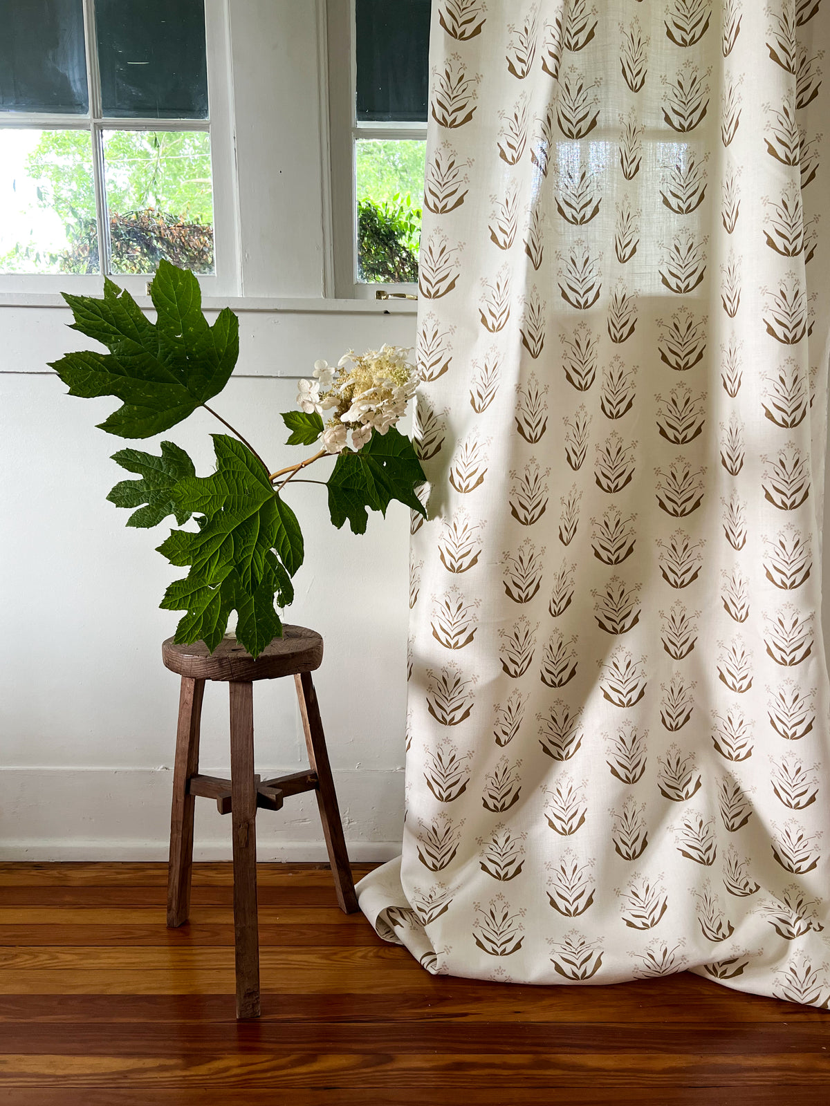 Greige Textiles&#39; Paige pattern: a hand-printed, mid-size floral design on natural linen, crafted for bespoke interior design applications including drapery, pillows, and upholstery