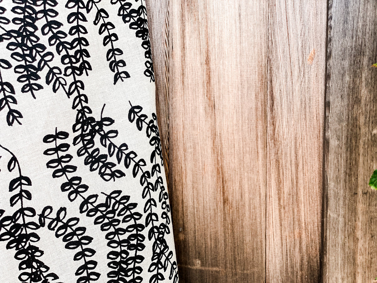 Antoinette pattern — a handmade linen fabric with a graceful trailing floral motif, crafted for pillows, drapery, and upholstery.