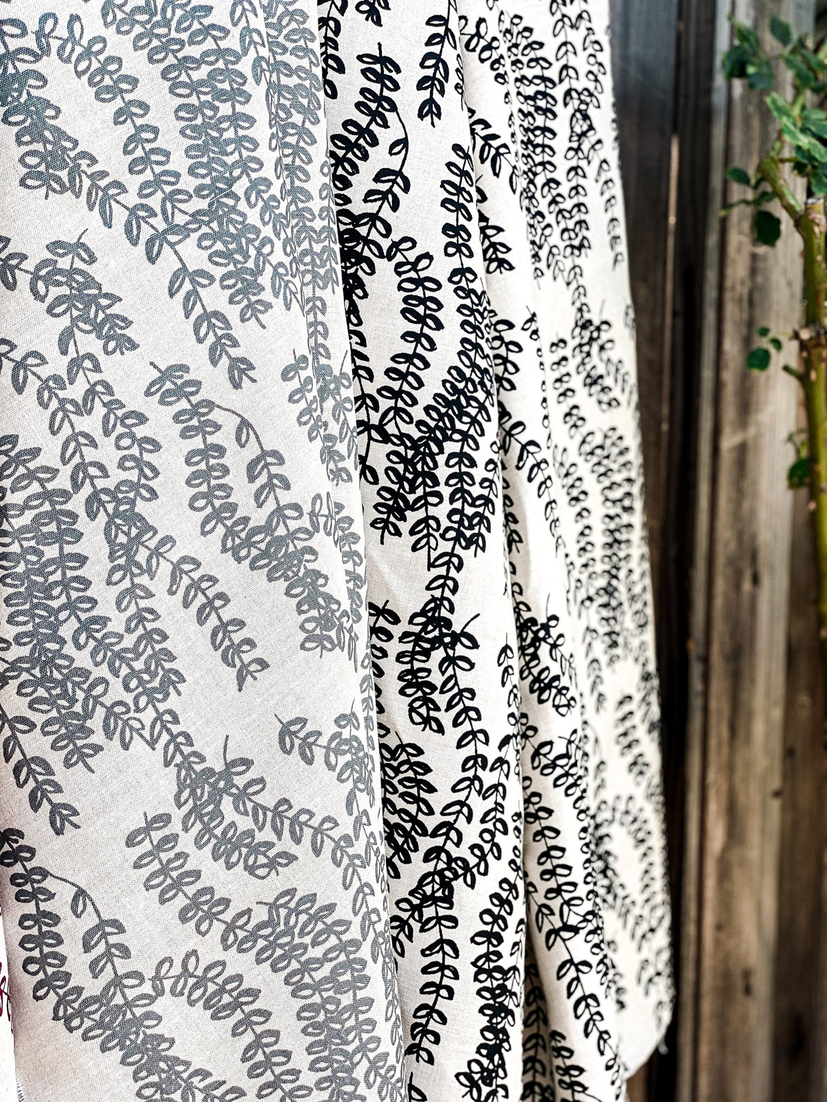 Antoinette pattern — a handmade linen fabric with a graceful trailing floral motif, crafted for pillows, drapery, and upholstery.