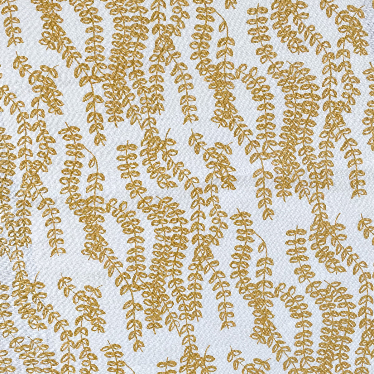 Delicate trailing floral design, Antoinette, screen printed by hand on natural linen, evoking the quiet strength of agrarian landscapes.