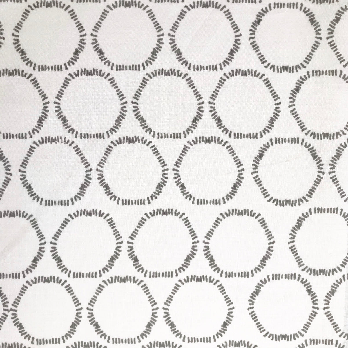 Cape by Greige Textiles — an organic open circular pattern hand-printed on Belgian linen, ideal for drapery, upholstery, and decorative accents in refined interiors.