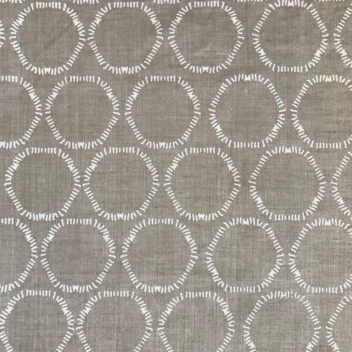 Cape pattern from Greige Textiles — organic, open circles hand printed on premium Belgian linen, suited for pillows, curtains, and light upholstery.

