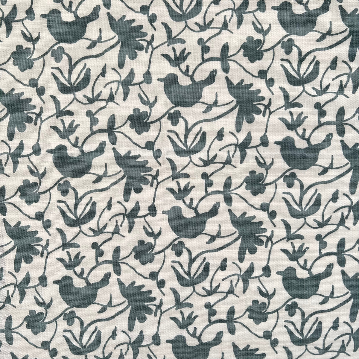 Artisan-printed Eliza textile — a lyrical blend of flowers and perched birds, inspired by nature and crafted for elevated interiors.