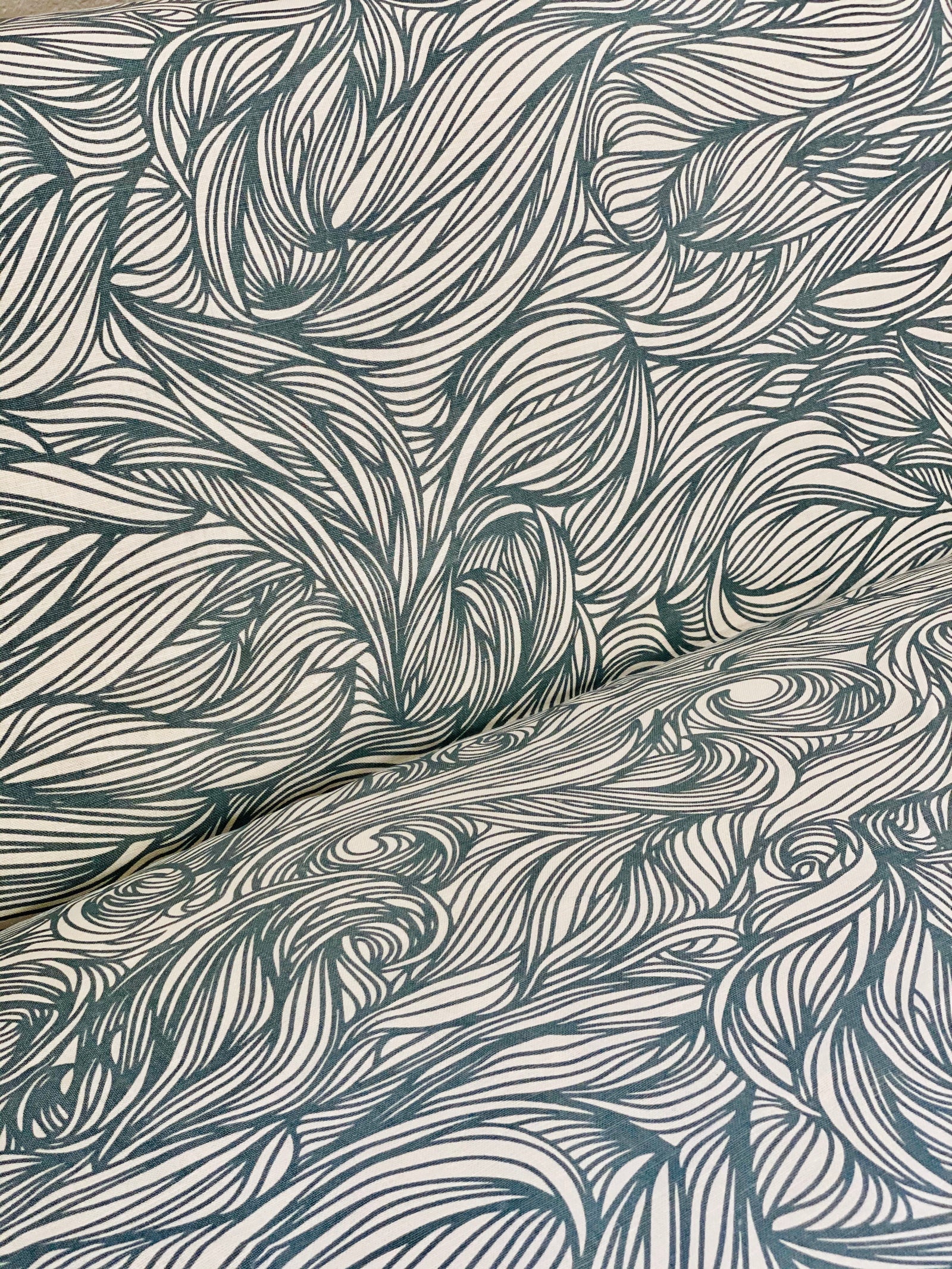 Trina Fabric Denim on Oyster Elevate your home with Greige Textiles' lively collection of hand screen-printed linen fabrics and artisan wallpapers