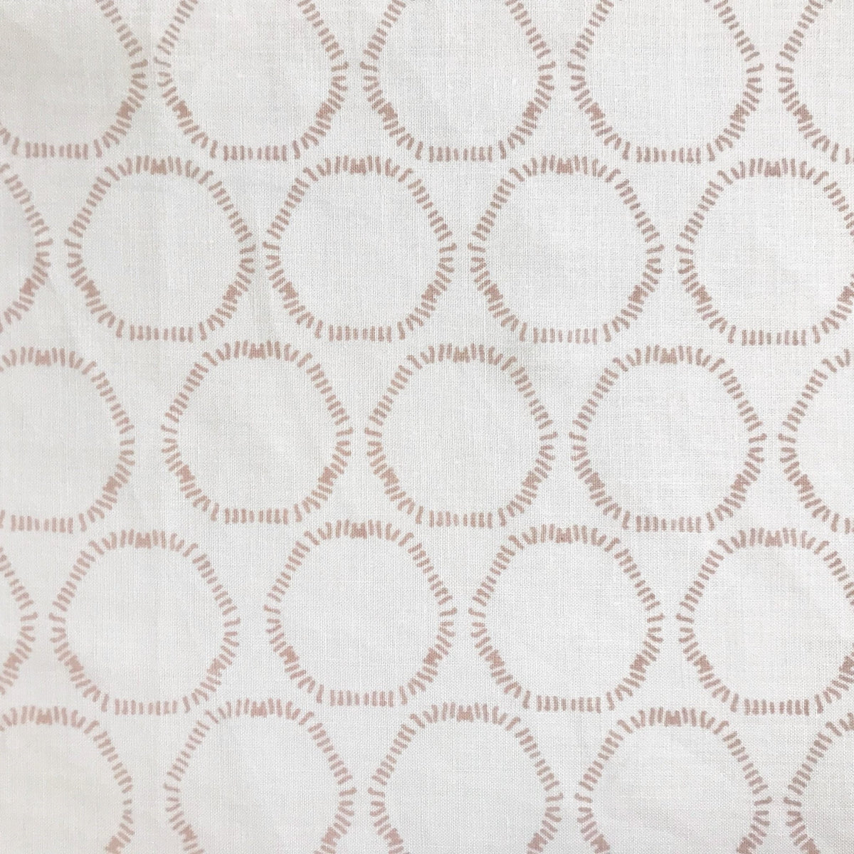 Cape pattern from Greige Textiles — organic, open circles hand printed on premium Belgian linen, suited for pillows, curtains, and light upholstery.