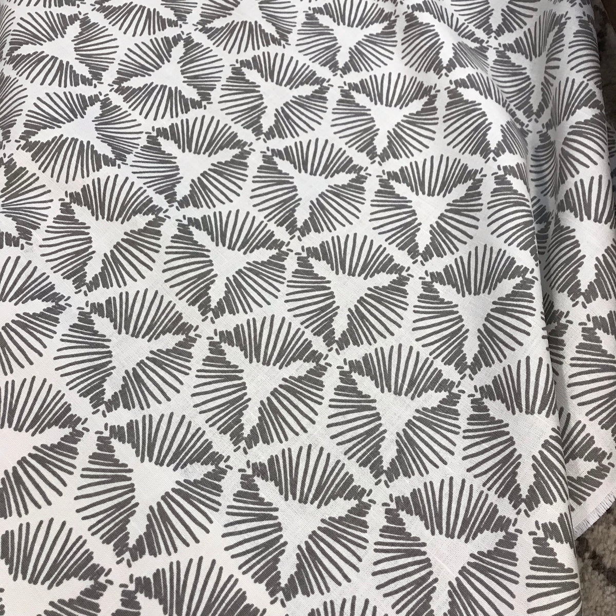 Cie – where geometry meets excitement. A bold starburst shield pattern printed on luxurious Belgian linen, designed to bring theatrical flair and flow to interior spaces. greige textiles