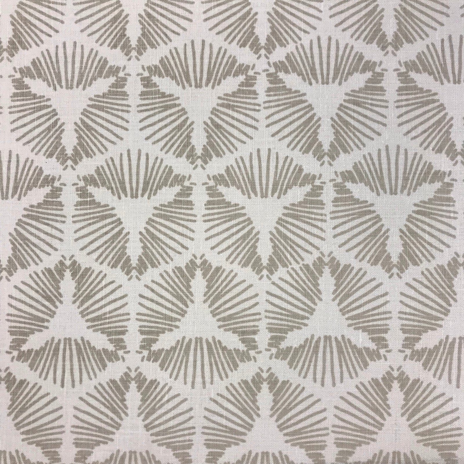 Cie by Greige Textiles channels bold movement and graphic drama in its radiant starburst shield pattern, hand printed on Belgian linen for statement-making design moments
