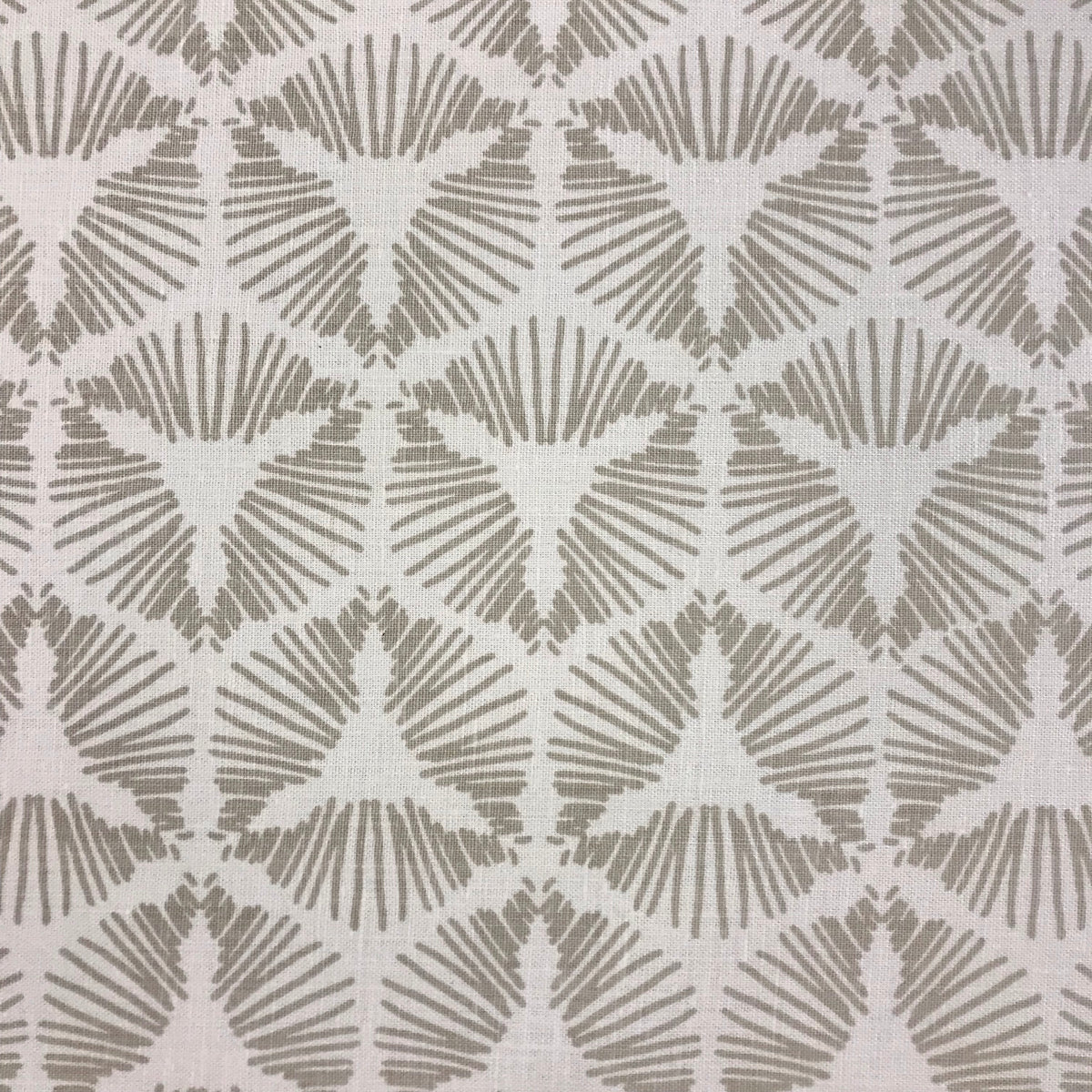 Cie by Greige Textiles channels bold movement and graphic drama in its radiant starburst shield pattern, hand printed on Belgian linen for statement-making design moments