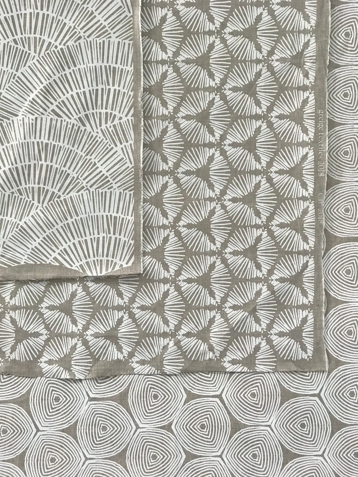 The Cie pattern radiates striking visual rhythm with its bold starburst shield design. A dynamic textile hand printed on Belgian linen, ideal for upholstery, cushions, and drapery in spaces that embrace graphic elegance.
