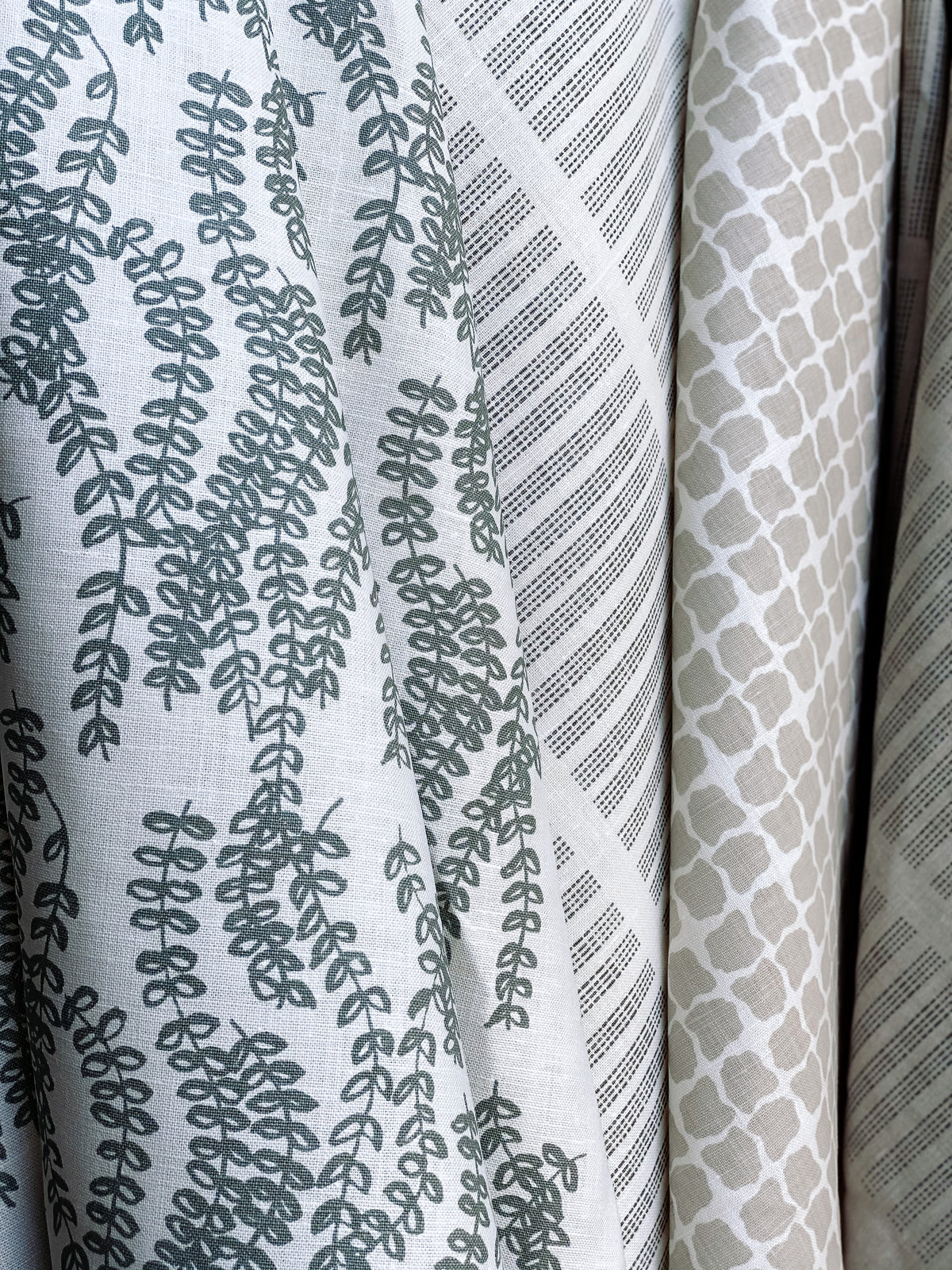 Antoinette pattern — a handmade linen fabric with a graceful trailing floral motif, crafted for pillows, drapery, and upholstery.