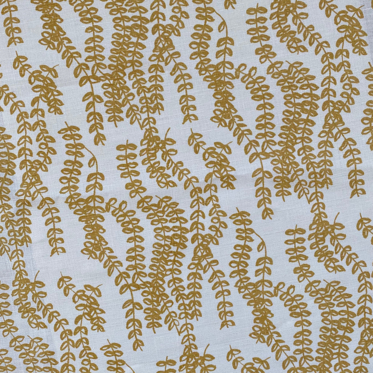 Delicate trailing floral design, Antoinette, screen printed by hand on natural linen, evoking the quiet strength of agrarian landscapes.