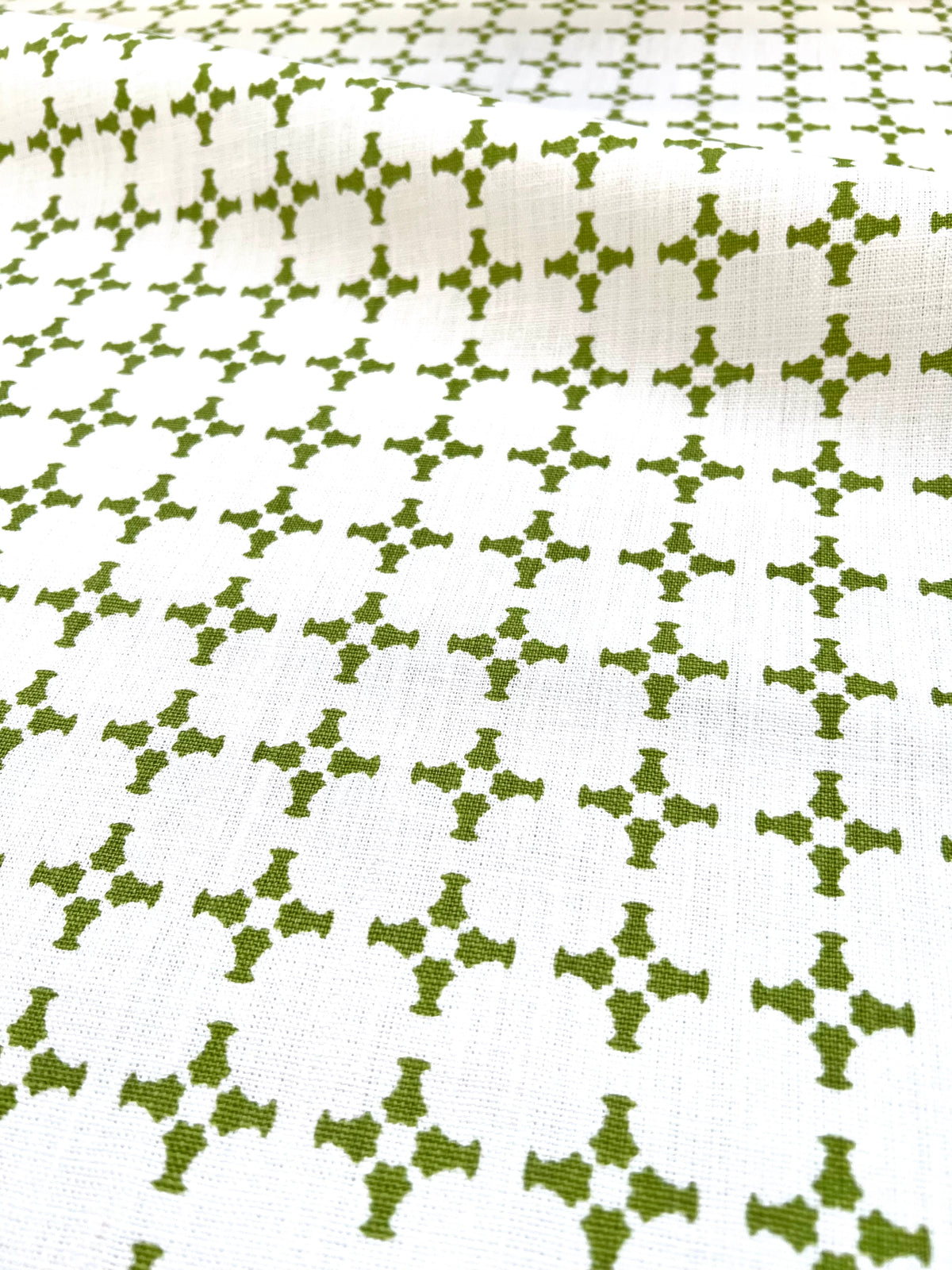 Greige Textiles’ CanCan — an airy, geometric linen fabric with a plaid-influenced cross motif, designed for timeless applications in residential and boutique commercial interiors