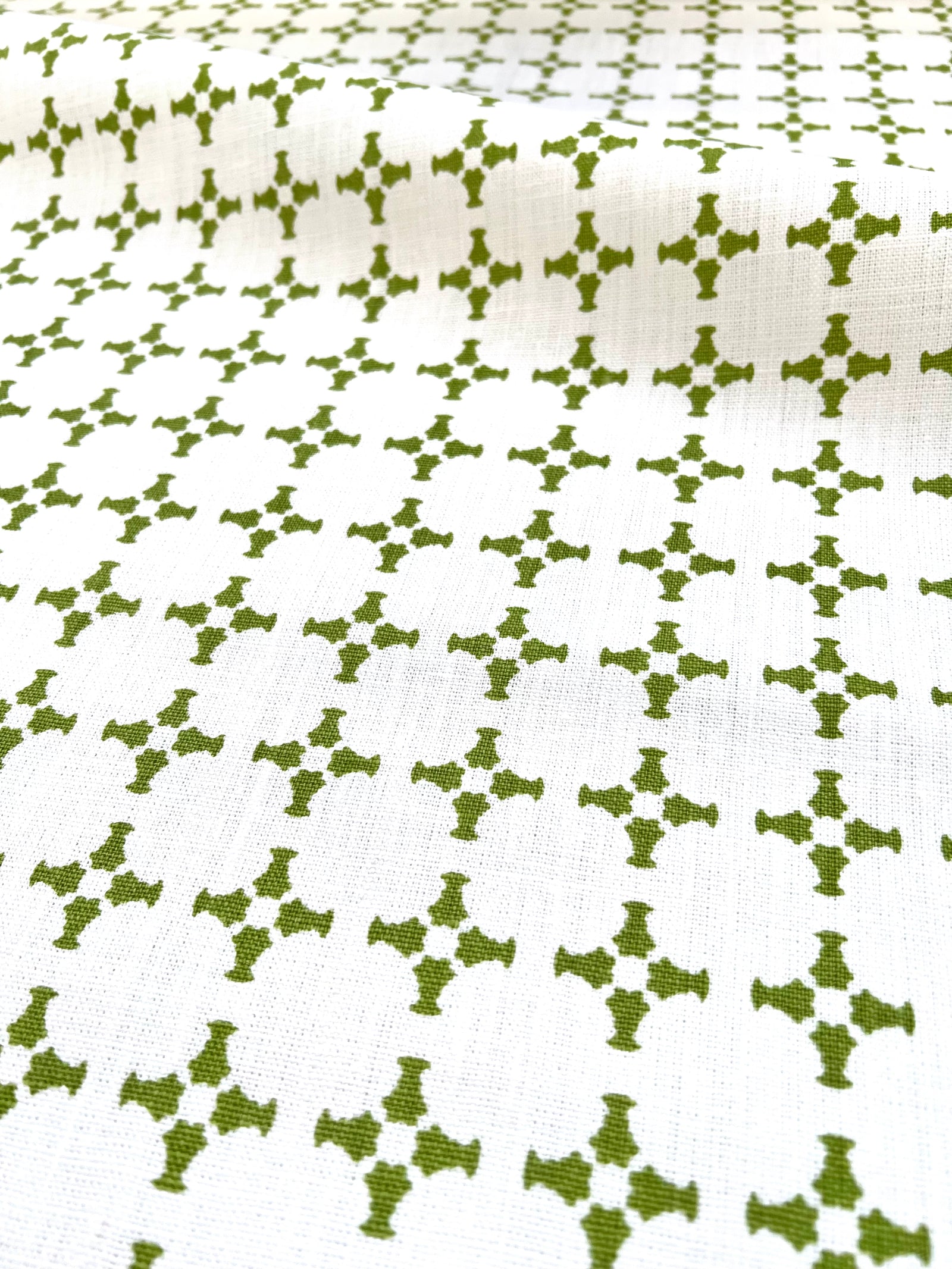 Greige Textiles’ CanCan — an airy, geometric linen fabric with a plaid-influenced cross motif, designed for timeless applications in residential and boutique commercial interiors