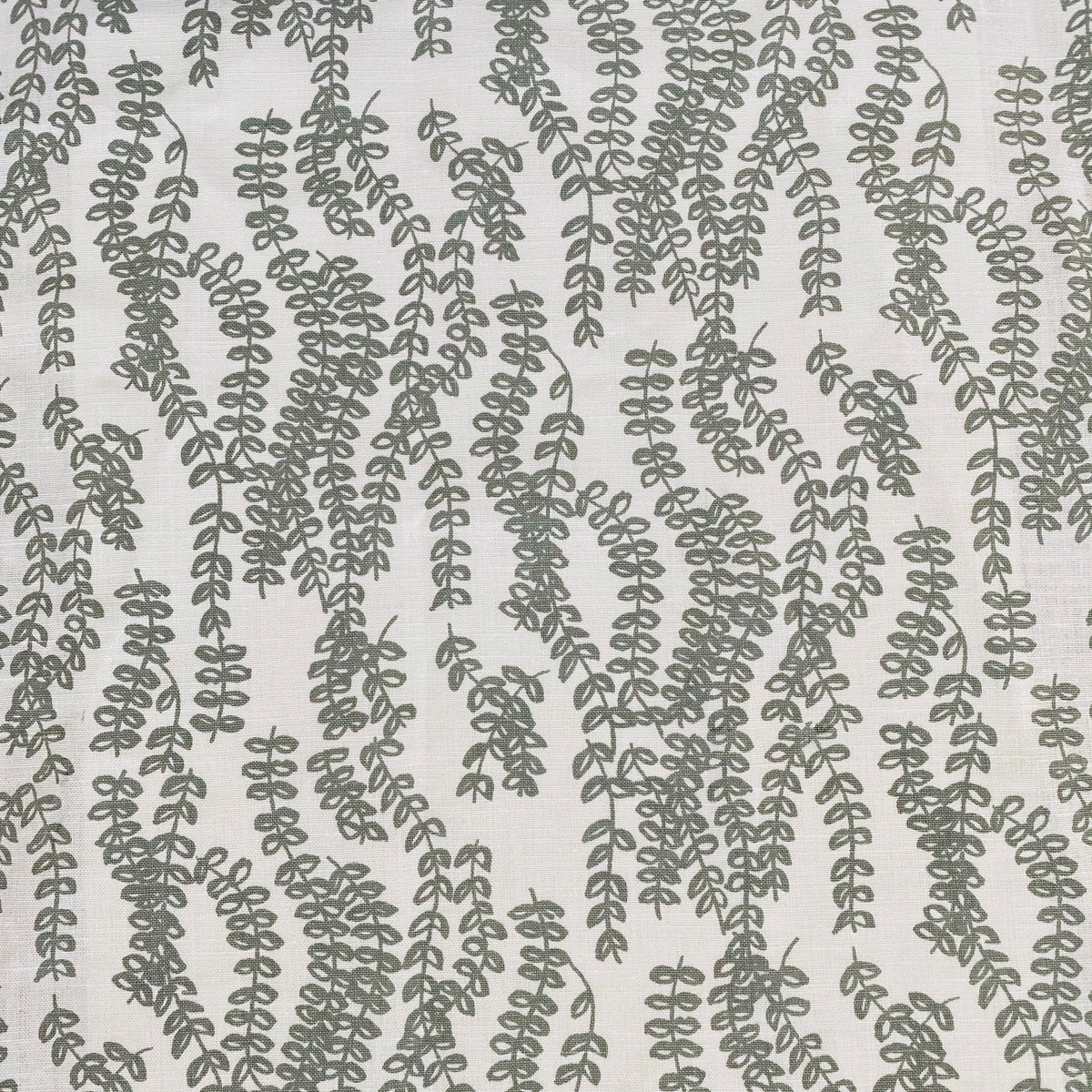 Antoinette pattern — a handmade linen fabric with a graceful trailing floral motif, crafted for pillows, drapery, and upholstery.